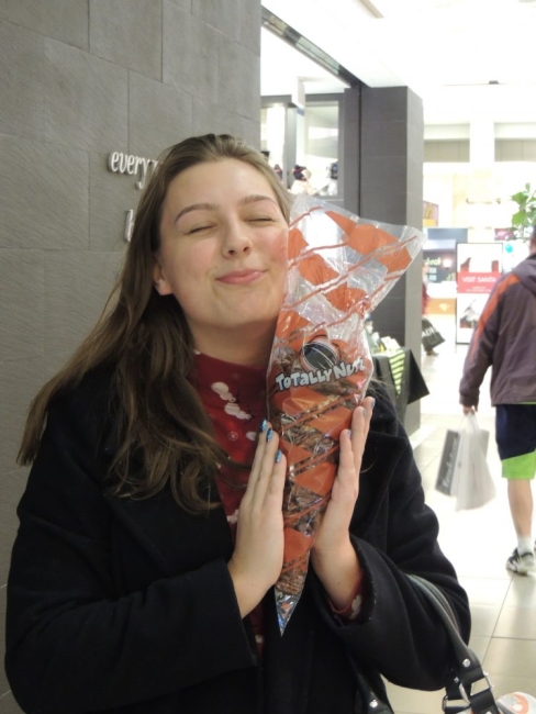 Tiffany holding a polybag of cinnamon roasted nuts 